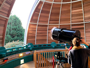 Dr Emily Sandford with a telescope at an observatory