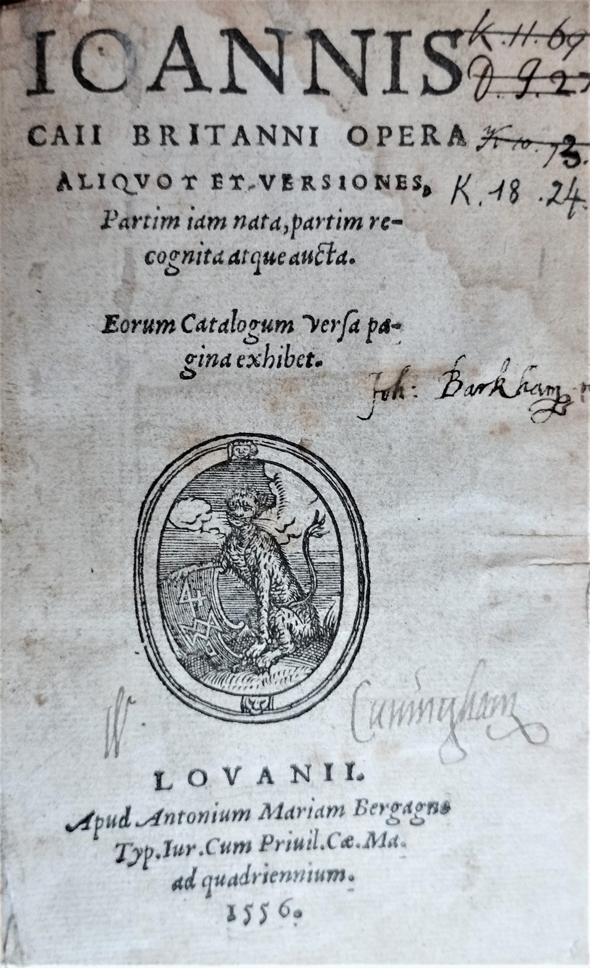 Title page of the book "De Canibus" by John Caius (1556). Several handwritten notes and a printer's device showing a dog. 