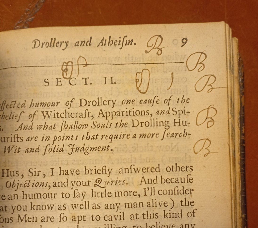 Ink annotations in the margin, as someone practises forming the letter B 
