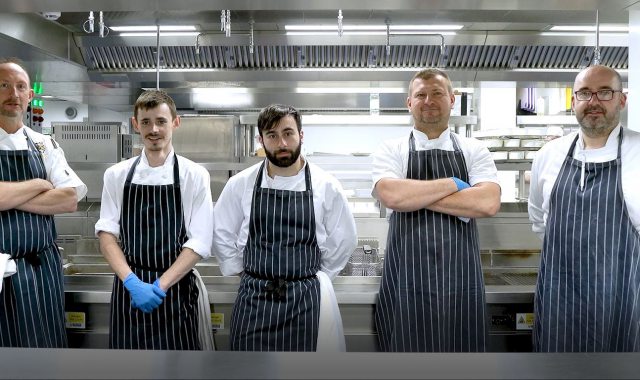 Five chefs in the Gonville & Caius College kitchen