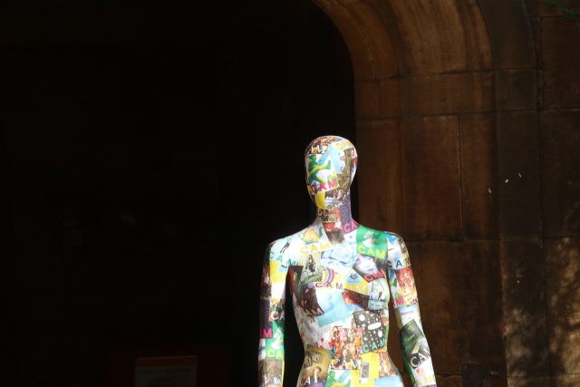 The torso and head of a colourful mannequin