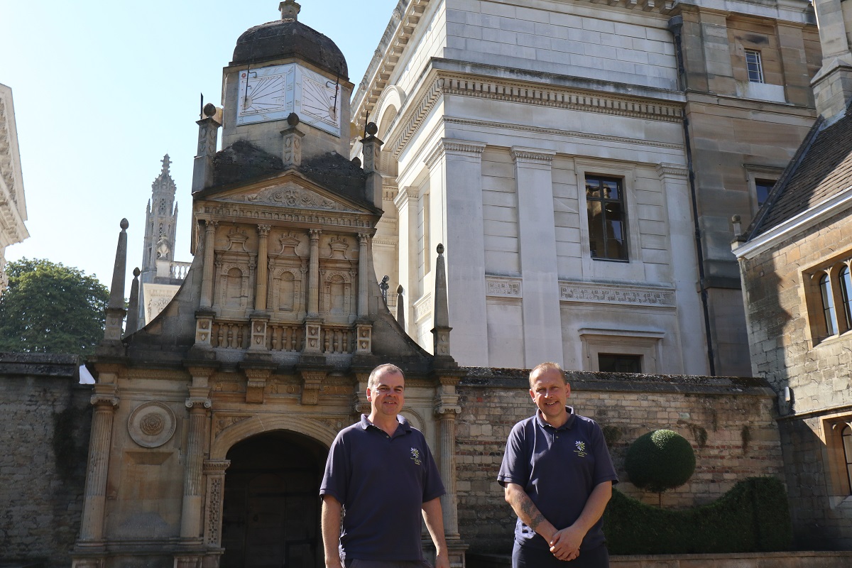 Chris and Michael Ford in front of the Gate of Honour in Caius Court