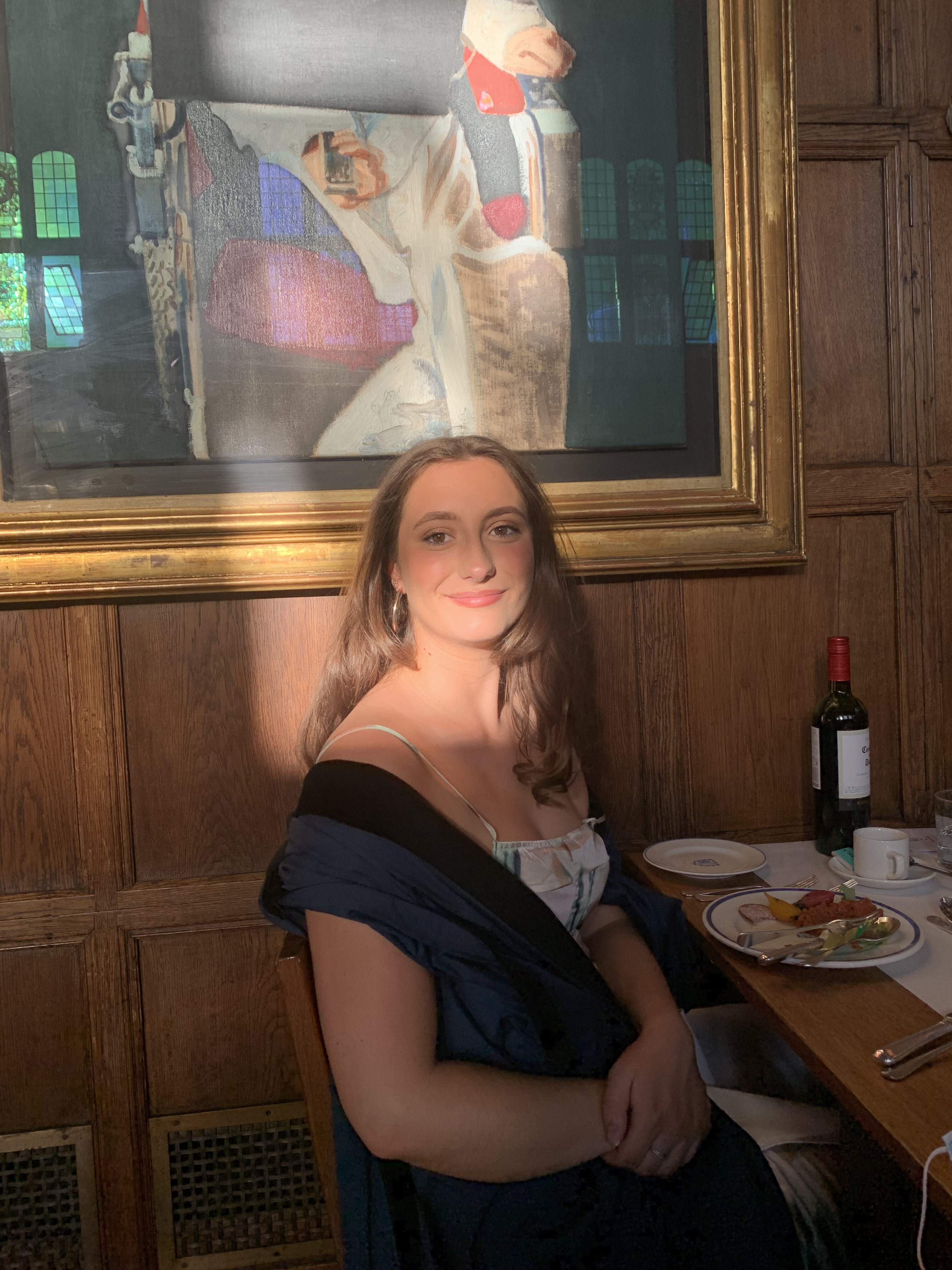 Picture of Grace at a formal dinner, smiling in a gown