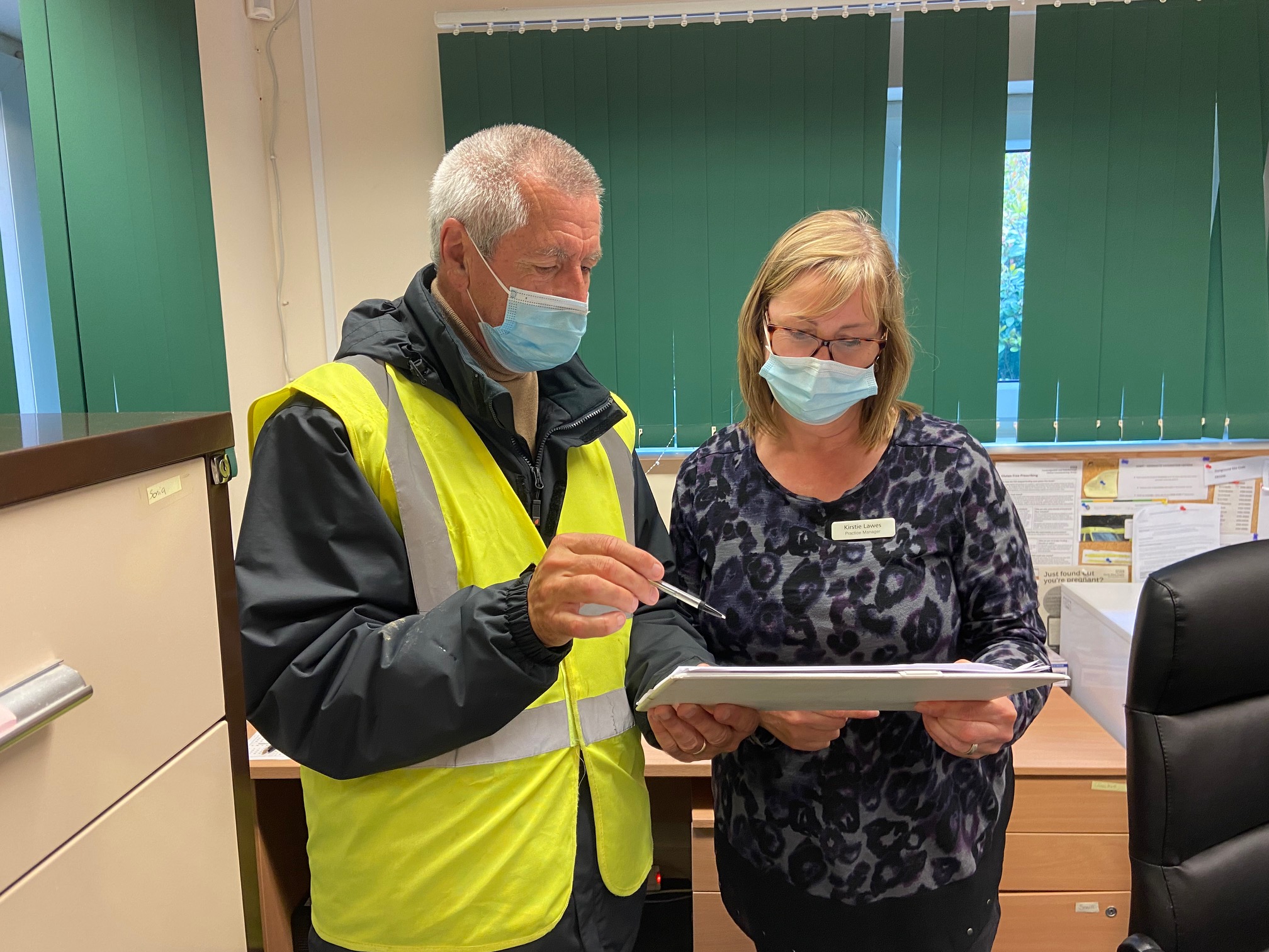 John Bufton discussing the vaccination procedures with the operations director