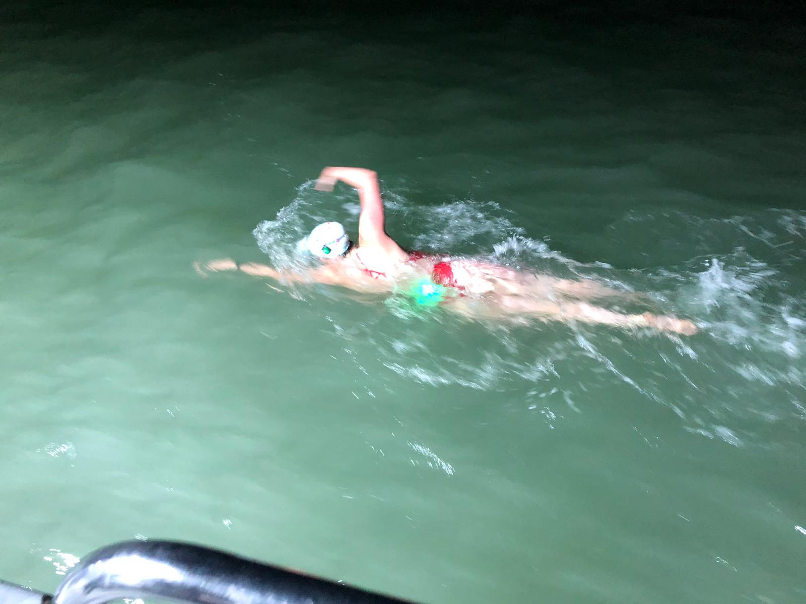 Charlotte Rowlands swimming in the dark in the English Channel