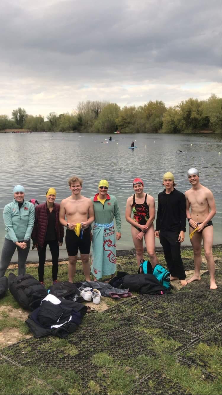 Seven swimmers standing in front of a lake at Milton Country Park