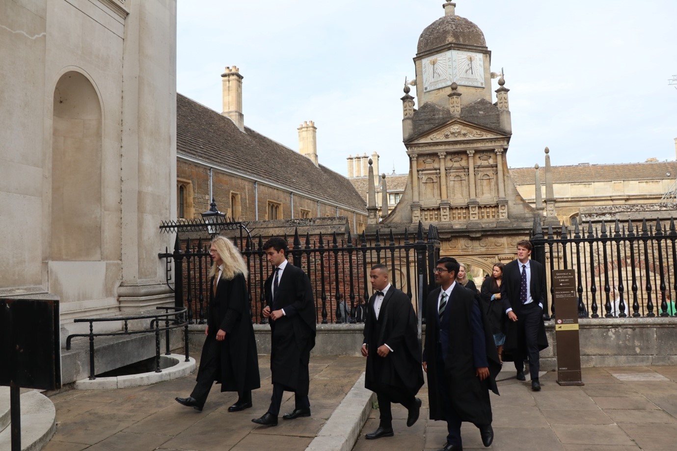 Students in academic gowns walking into their matriculation at Caius