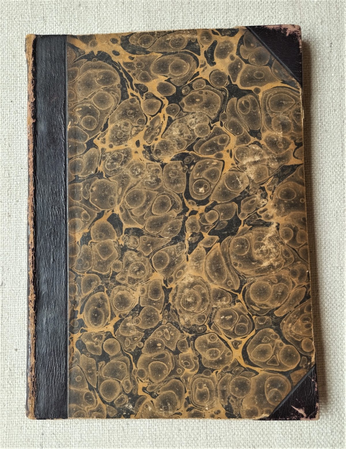 Binding of the book: quarter calf and tips, marbled boards. 