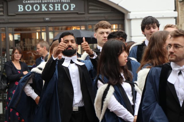 Students in graduation gowns queuing