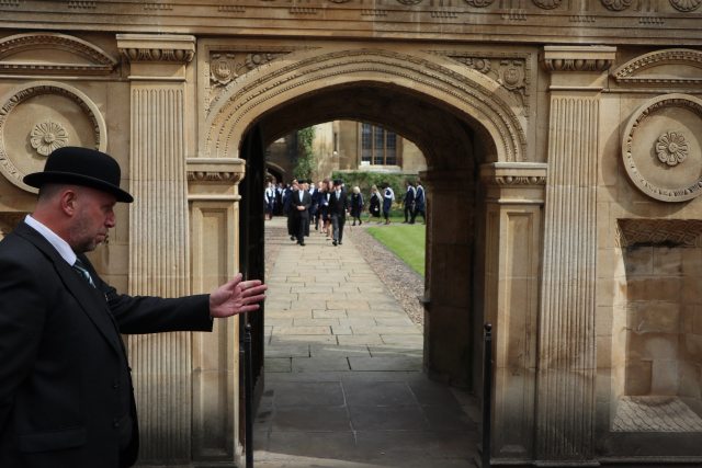 The Caius General Admission procession walks towards the Gate of Honour