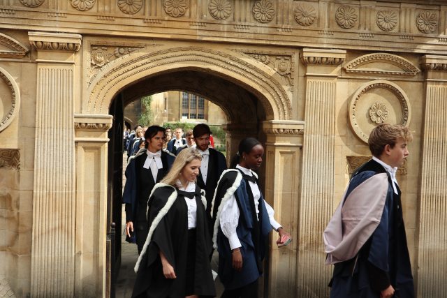 Graduands process out of the Gate of Honour into Senate House Passage